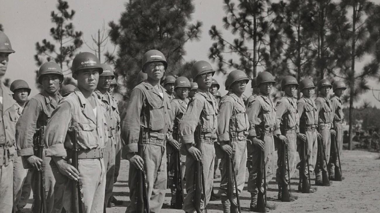 men in military uniform lined up for inspection