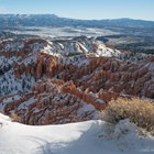 The amphitheater filled with red rock formations, covered in snow.