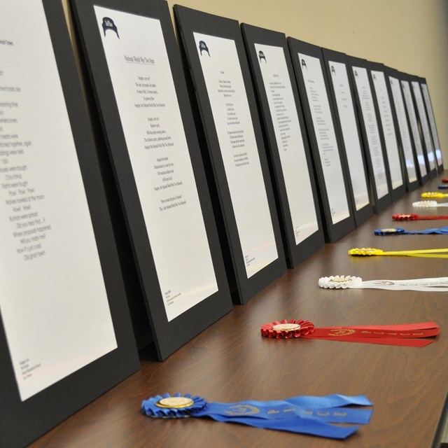 Ribbons and poems are displayed for student recognition.