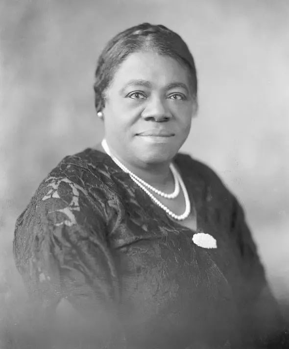 Photographic portrait of Mary McLeod Bethune wearing a formal dress and double strand of pearls.