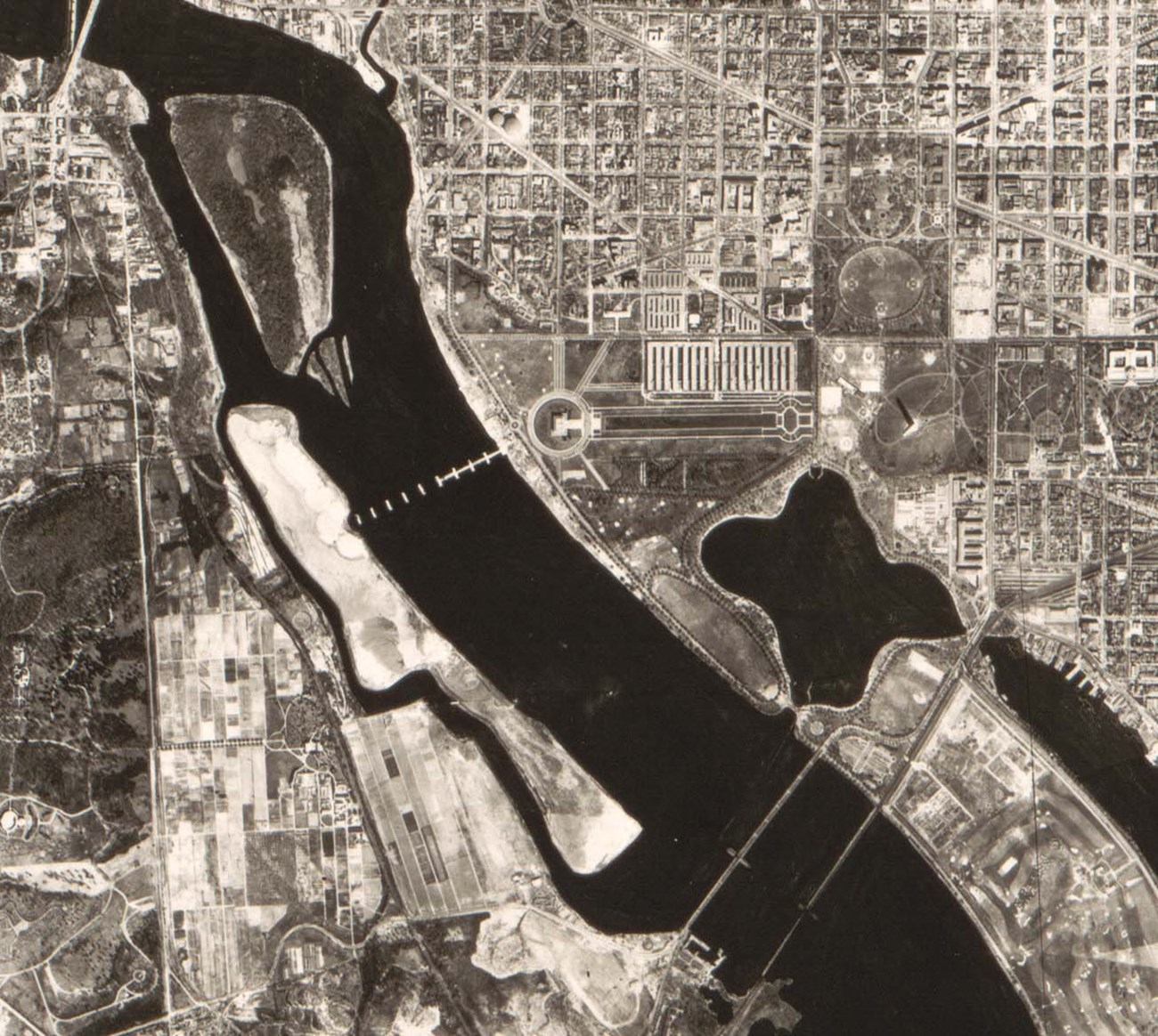 An aerial image of a section of Washington, DC including the elongated Columbia Island near the western shore of the Potomac River.