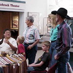 Artist in Residence, Robert White, talks with visitors about the meaning behind his art work.