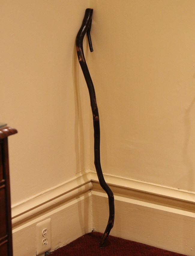 Wooden cane leaning against a corner
