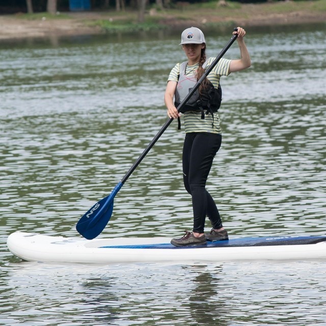 Woman wearing a life jacket on paddle board