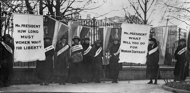 Women holding placards for women's suffrage in front of White House