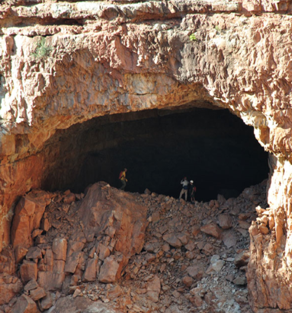People at an entrance to a large cave
