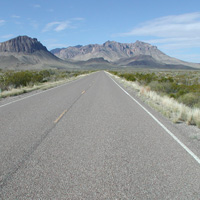Nugent Mountain and Pummel Peak rise above the road. Nugent Mountain and Pummel Peak rise above the road.