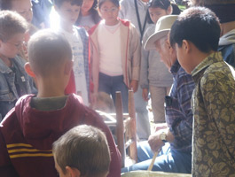 Children observing chair caning