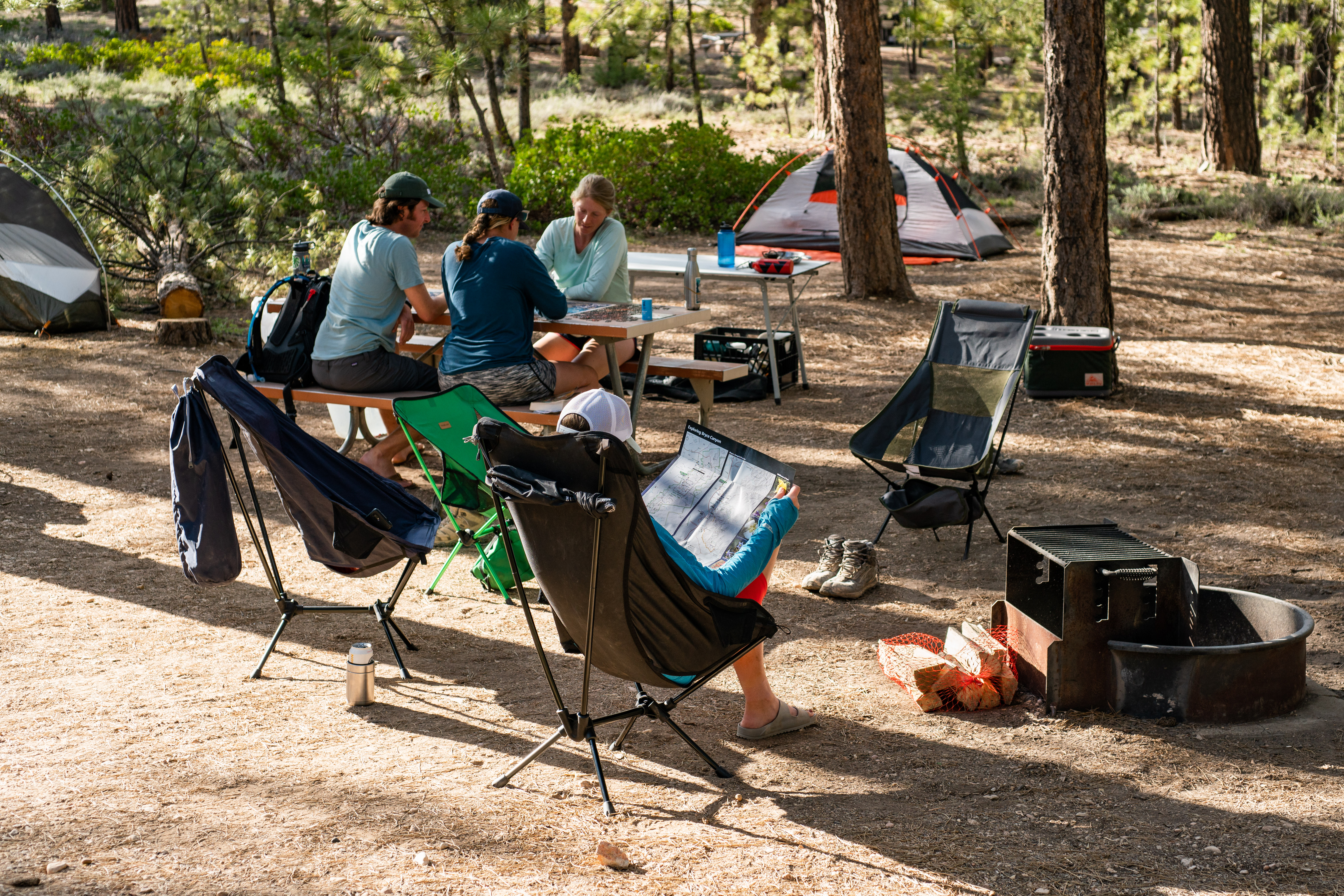 A group of campers relax in a campsite
