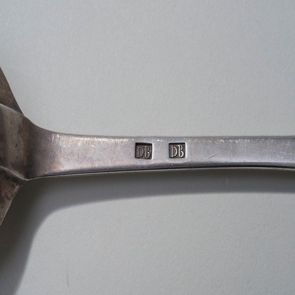 A close up of one of Duncan Beard's silver spoons showing his mark.