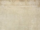 Color image of the handwritten Declaration of Independence with brown ink on cream paper.The