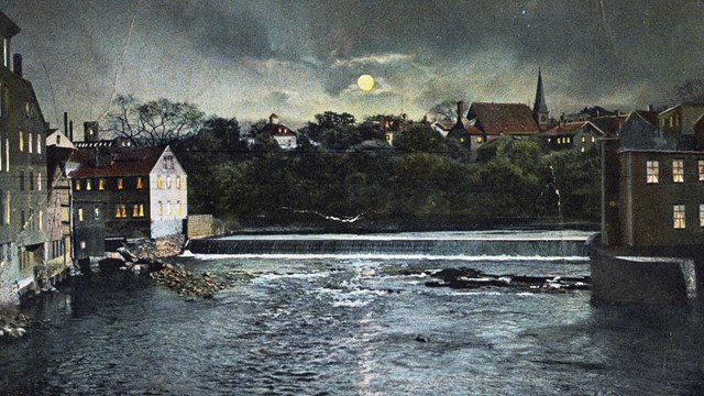 Blackstone River at night with dam and mills