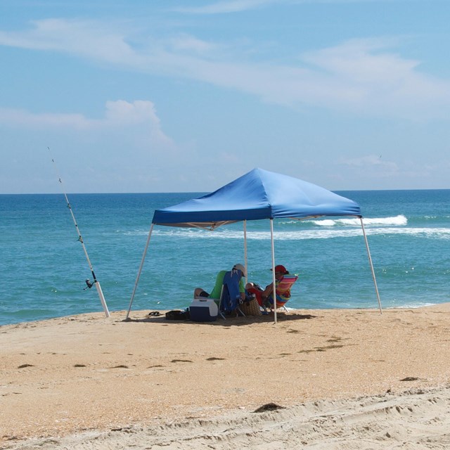 Beachgoers with Fishing Pole and ORV