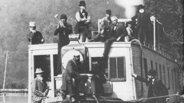Historical black and white photo of canallers aboard a canal boat.