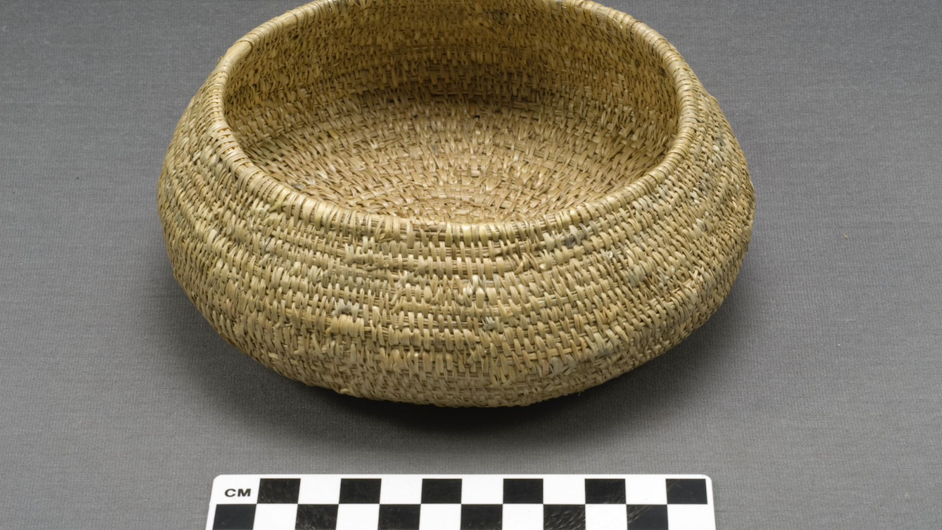 A woven bowl next to a ruler