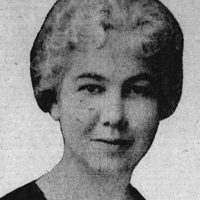 A photograph of a woman from the neck up.