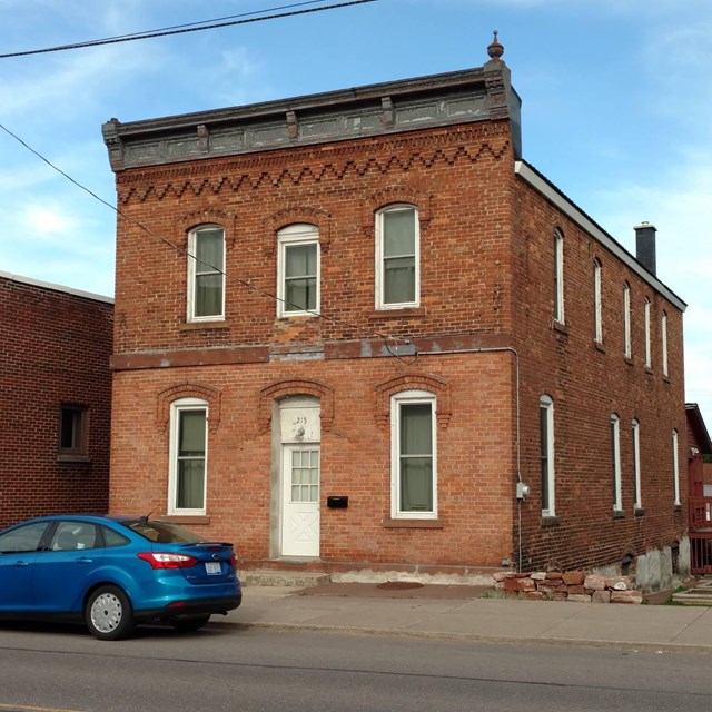 A two-story brick building with numerous windows.