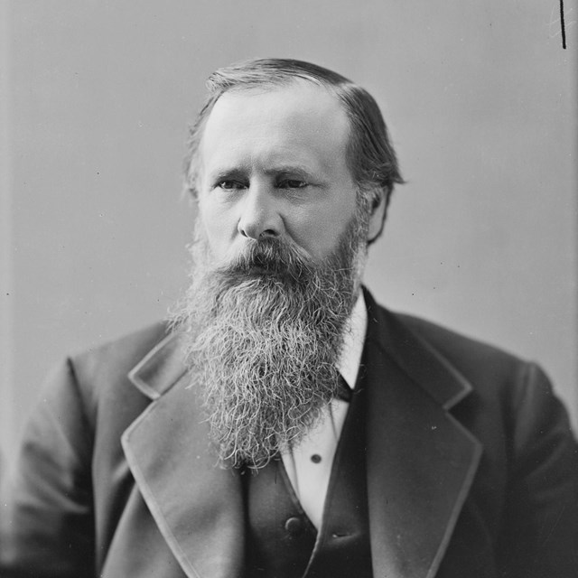 A portrait photograph of a man with a long beard.