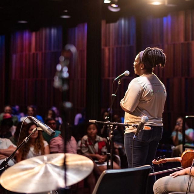 Singer on a stage performing to an audience