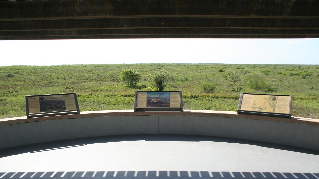 Circular, concrete battlefield overlook with three interpretive waysides and a wooden pergola.