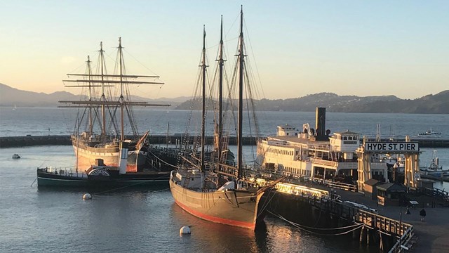 View of Hyde Street Pier and ships in the sunset