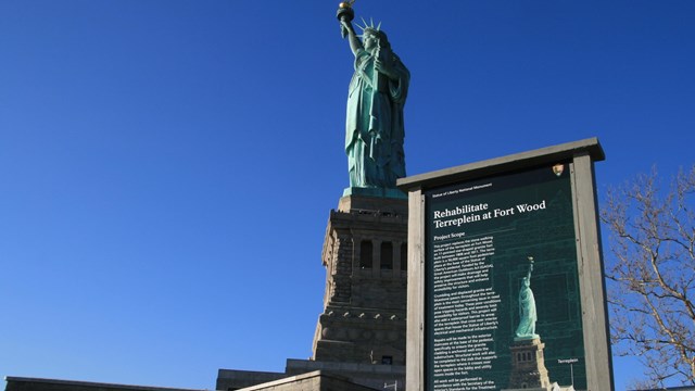construction sign for project in front of statue of liberty