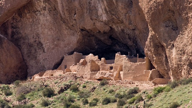 Cliff dwelling in desert landscape