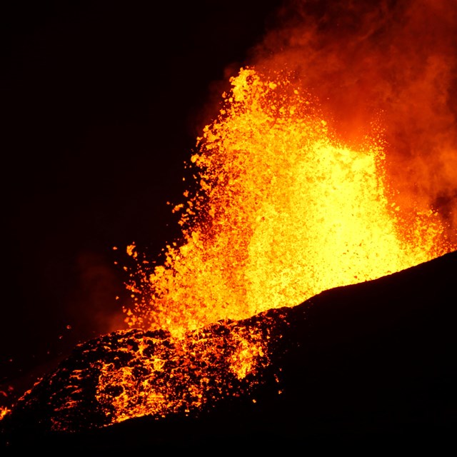 molten lava erutping at night
