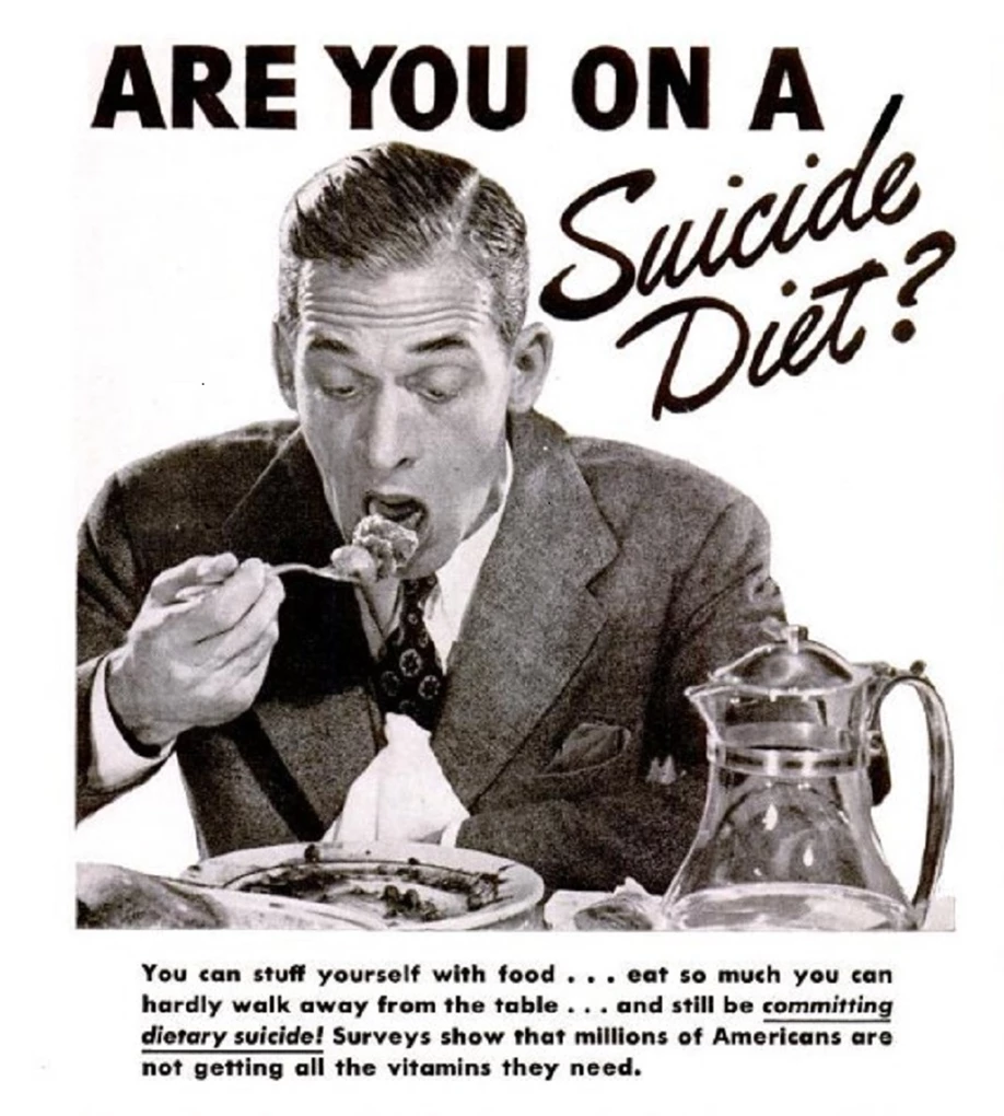 Black and white photo of a man in a suit about to eat a large forkful of food.