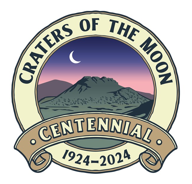 Illustration spatter cones with banner scroll saying centennial. Text circles image with the words "Craters of the Moon" and "1924-2024"