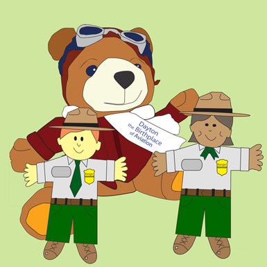 WILBEAR cartoon on a green background with flat rangers in gray shirts, green pants and brown flat hats.