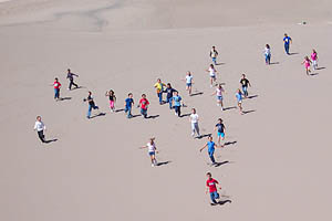 children running down dunes children running down dunes
