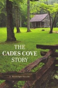 A book cover with a wooden fence in the foreground and a cabin in a grassy field surrounded by trees in the background.
