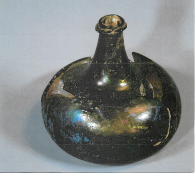 a greenish brown bottle with a skinny neck and bulbous bottom
