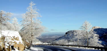 A snowy roadside view of Knife Edge Point and beyond to Montezuma Valley