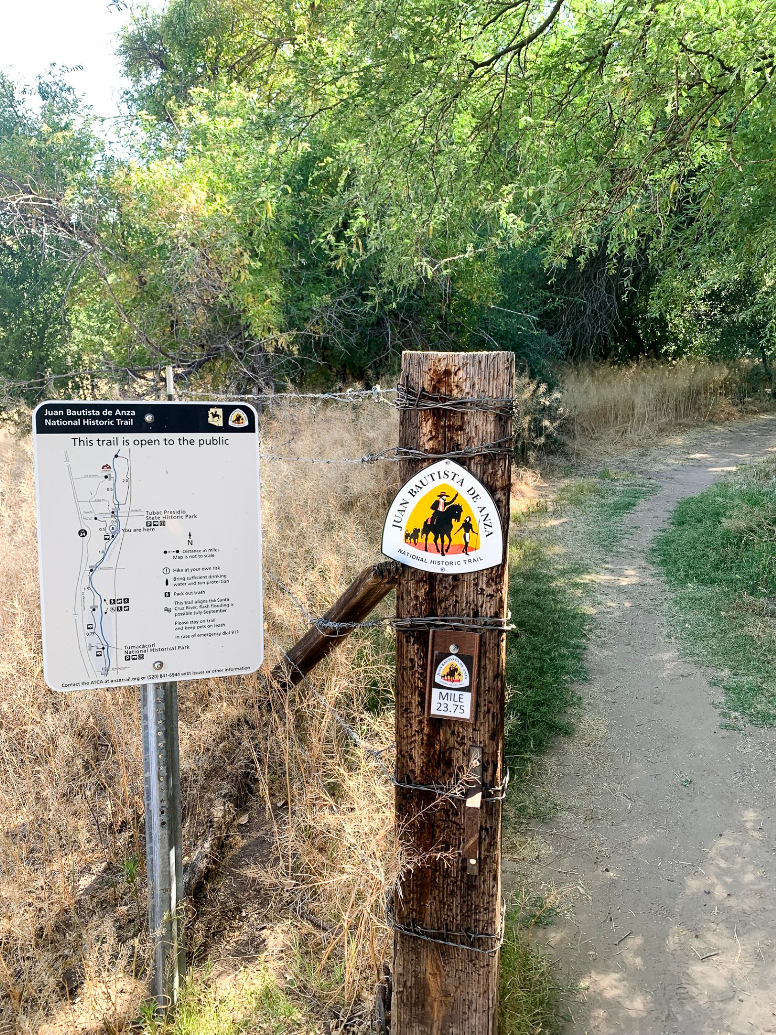 ATC 1 A post with a map of the Anza Trail stands next to a wooden post with an Anza Trail logo and mile marker