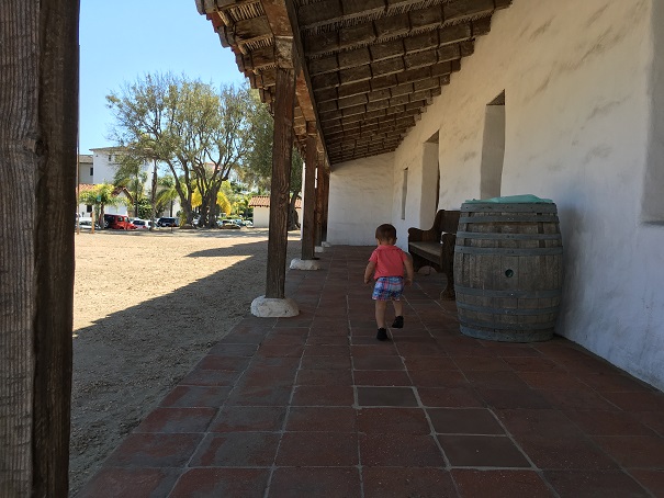 Young child walking down a hallway at a historic Mission. Young child walking down a hallway at a historic Mission.