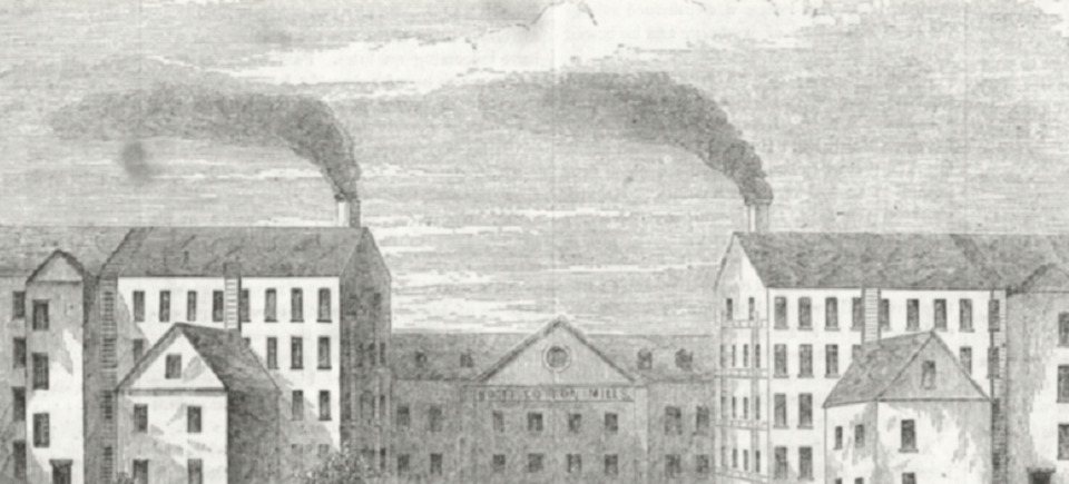 A mill building, shown from the second story up to the fifth, is spewing smoke from stacks on either side of the clocktower in the middle