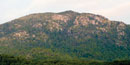 The huge gray granite boulders rise above the green ridges of Old Rag Mountain.