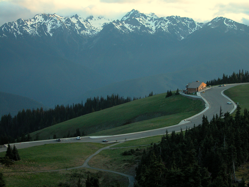 A view of the Hurricane Ridge Day Lodge from above, with the Olympic Mountains in the background.