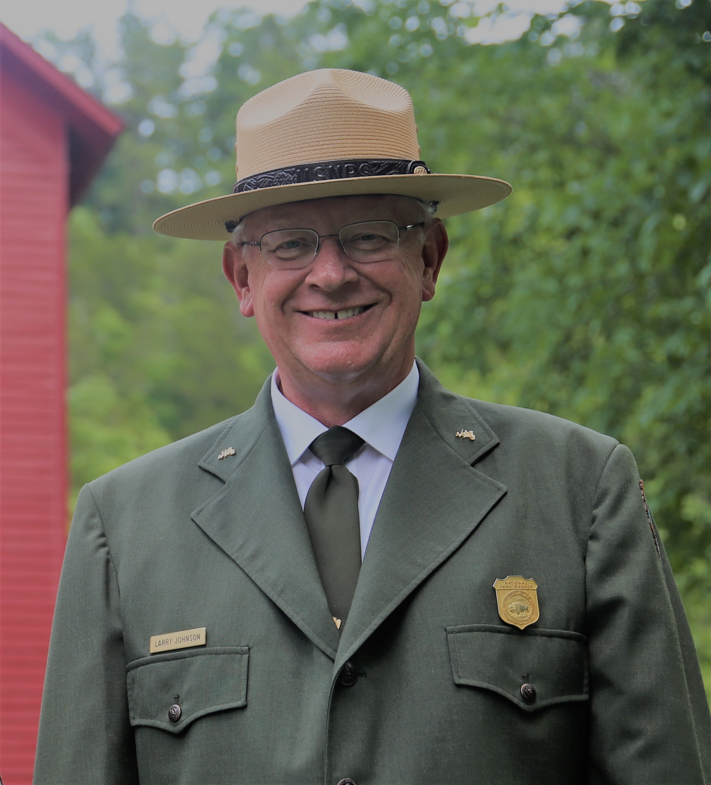 Superintendent Larry Johnson in green park service dress uniform and flat hat