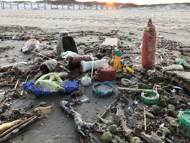 A pile of plasitc trash on the beach.
