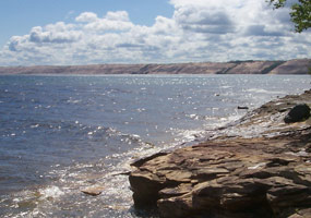This sandstone shelf lies near Au Sable Point, with the magnificent Grand Sable Dunes rising high above Lake Superior in the background.