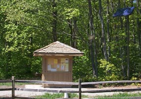 This quaint building houses solar equipment to power the water well. The solar panel is on a tall pole at the right corner. This quaint building houses solar equipment to power the water well. The solar panel is on a tall pole at the right corner.