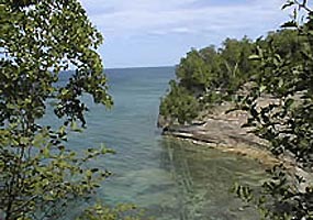 This cove is nestled in the cliffs along Grand Island in Lake Superior. This cove is nestled in the cliffs along Grand Island in Lake Superior.
