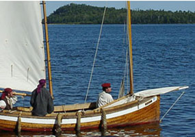 A wood sailboat - called a Mackinaw - approaches a dock at Grand Portage on Lake Superior. A wood sailboat - called a Mackinaw - approaches a dock at Grand Portage on Lake Superior.