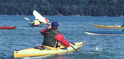 Kayakers enjoying their day on Lake Superior. Grand Island is in the background.
