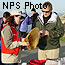 Volunteer docent with whale baleen talking with a park visitor