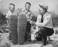1950s Superintendant Lewis interprets the saguaros for two young visitors