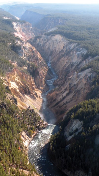 Overhead view of the Grand Canyon of the Yellowstone, with the Lower Falls at the bottom of the scene, and the canyon extending to the top of the scene.